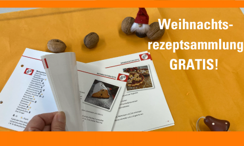 Die große Weihnachtsrezeptsammlung wird gerade durchgeblättert. Daneben sitzt ein kleiner Weihnachtsmann und es liegen Nüsse drumherum.